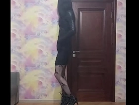 Slender crossdresser smokes and poses in tight dress